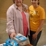 Volunteers Marsha Sherman and Ashley Johnson from in gym.